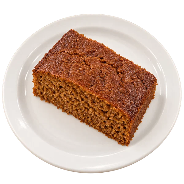 A slice of ginger spice cake on a white plate